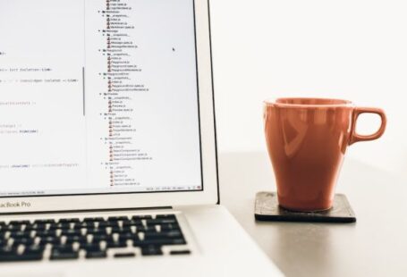 Python Framework - turned on MacBook Pro near brown ceramic mug