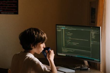 Coding - Boy in White T-shirt Sitting on Chair in Front of Computer